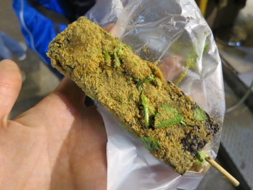 Pig's Blood Rice Pudding (or Pig's Blood Cake) -- a mixture of sticky rice and pig's blood that is coated in peanut powder, cilantro, and served up on a stick