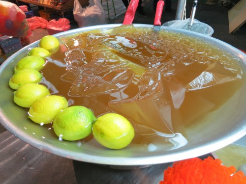 A large tray of the jello-like aiyu jelly, which is served over ice in a lemonade-like drink