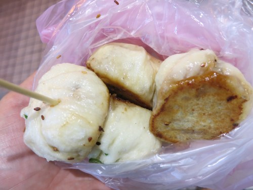 Fried Bao, or small dumplings that are stuffed with pork or veggies and fried up in huge pans until they are ready to burst