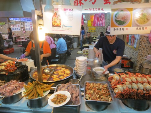 A seafood vendor showing off his edible wares