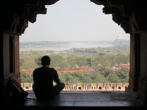 Looking out over the Yamuna River towards the Taj Mahal in the distance