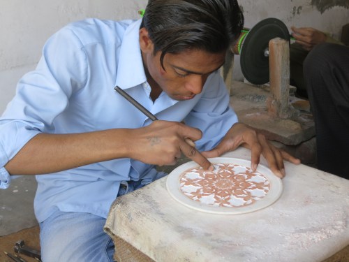 An artisan carved an intricate pattern into marble