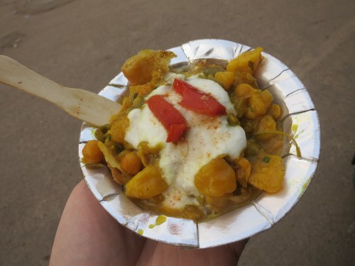 Chole Bhature (I think) -- a small dish of cracked Bhature (a deep-fried, leavened bread) that is then coated in Chhole (spicy chick peas) and served with a wooden spoon