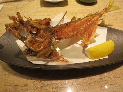 To show an added level of respect for the fish, once you've finished the sushi, the chef whisks away the remaining carcass, fries it up in a wok, and reserves it back to you, meant to be enjoyed like a crispy, salty cracker.  So even though its final moments weren't the most enjoyable, at least nothing went to waste.