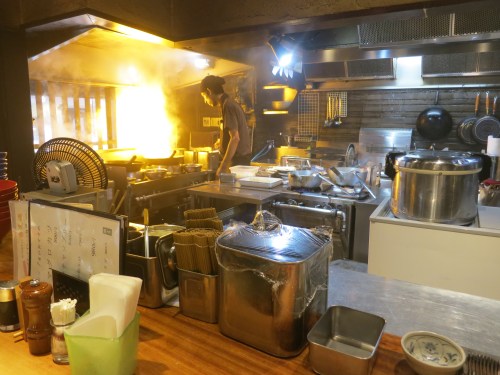 I found a great ramen shop with an interesting twist -- they are scorch the soy sauce base of their ramen broth, as seen here