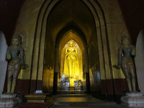 One of 4 massive golden Buddha images within the Ananda Temple