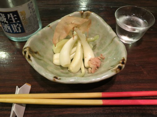 Pickled spring onions, offering a palette-cleansing, garlicky punch in the face to go with that glass of booze