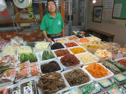 A friendly vendors offering up samples of his salted, pickled, fermented, and just generally preserved foods